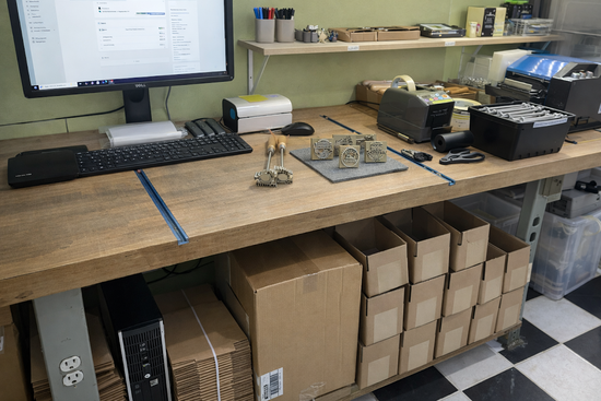 Packaging and shipping workstation with boxes and computer equipment